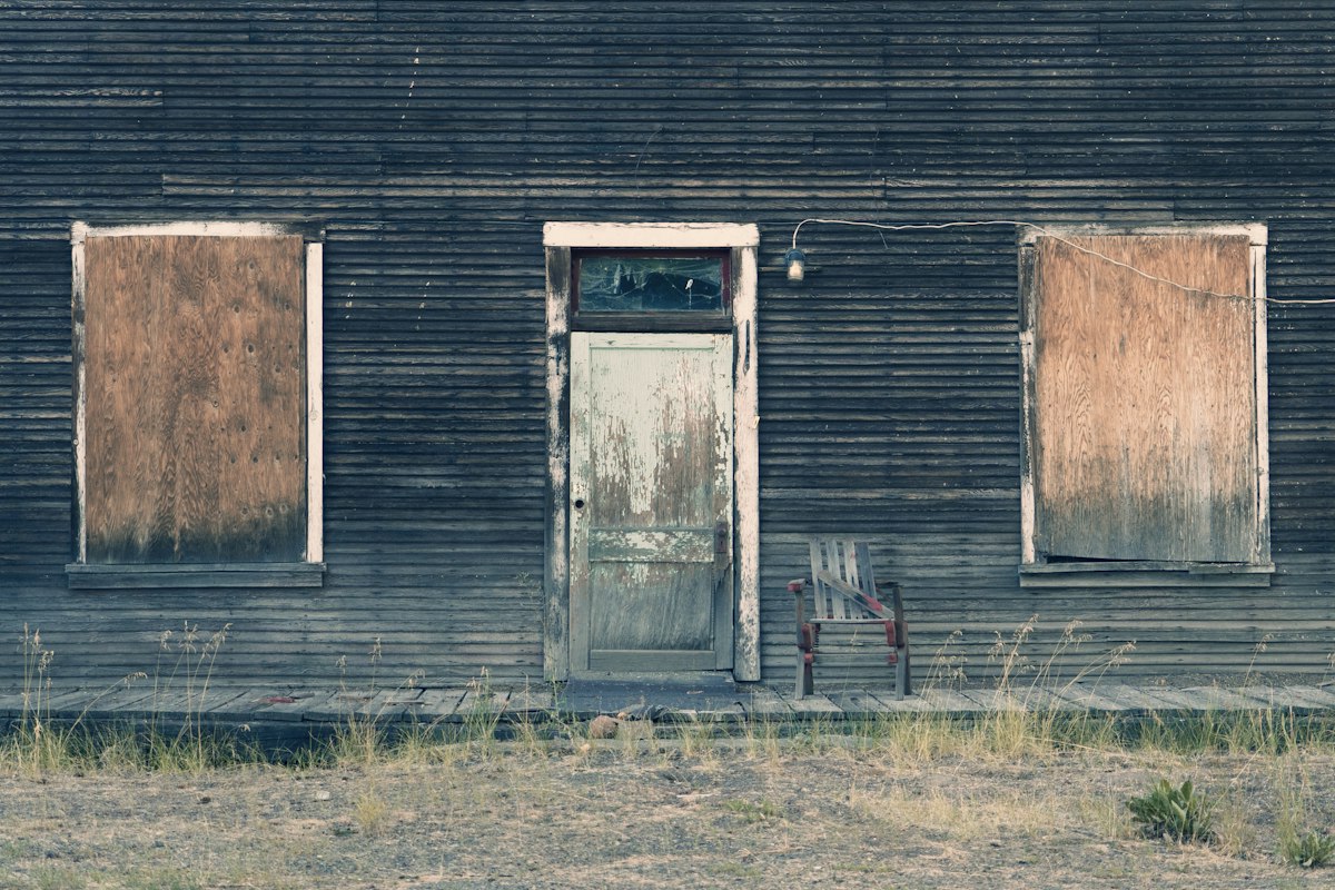 A weathered doorway in warm, low light